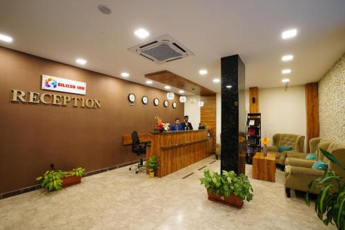 a reception area of a hospital with people in a lobby at Silicon Inn Hotel Bangalore Airport in Devanahalli-Bangalore