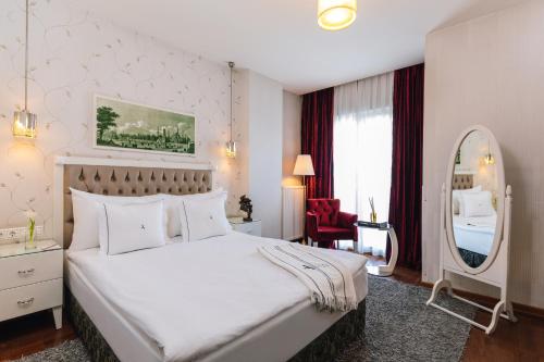 a hotel room with a bed and a dresser at Hotel Amira Istanbul in Istanbul