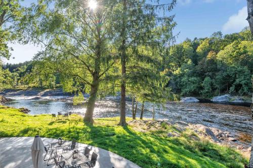 a view of a river with tables and chairs at Boen Gård in Kristiansand