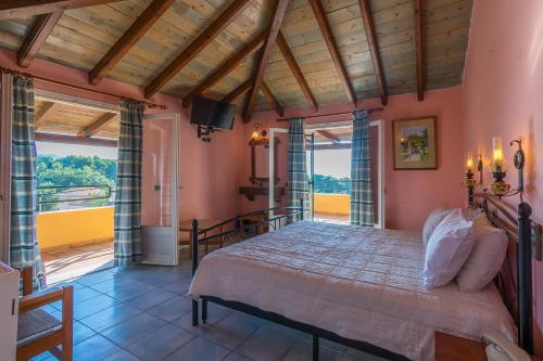 a bedroom with a bed in a room with windows at Villa Yannis in Kato Korakiana