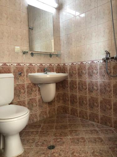 a bathroom with a toilet and a sink at Relax Guest House in Burgas