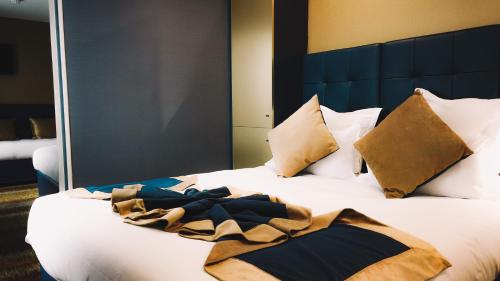 a bedroom with a bed with a blanket on it at Trianon Gare de Lyon in Paris