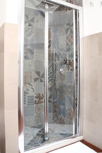 a shower with a glass door in a bathroom at Alla Corte del Conte in Conversano