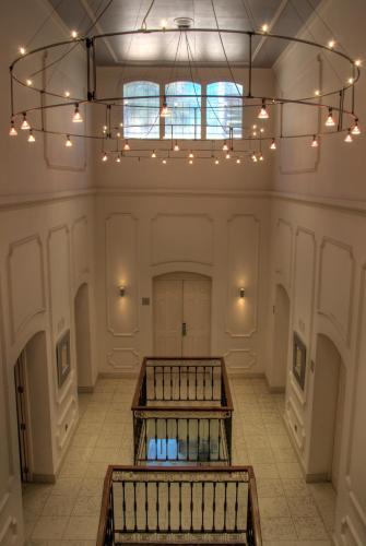 a large room with a chandelier and two benches at Catedral Almería in Almería