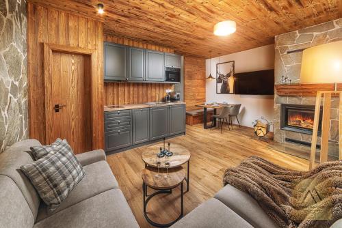 a living room with a couch and a fireplace at Apartment Claudie de Luxe in Demanovska Dolina