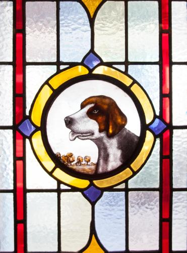 a dog with a bowl of food in a stained glass window at Club House Hotel Kilkenny in Kilkenny