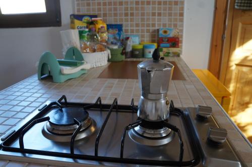 a tea kettle sitting on top of a stove at antonella home in Brindisi