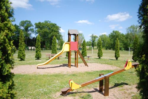 a playground with a slide in a park at Domaine Les Acacias in La Ville-aux-Dames