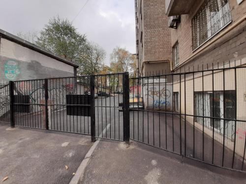 a black fence in front of a building at Апартаменты Marin в самом центре in Kharkiv