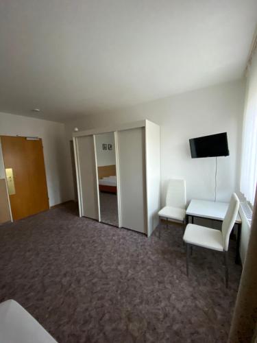 a hotel room with a couch and a tv at Hotel Seehaus in Horn-Bad Meinberg