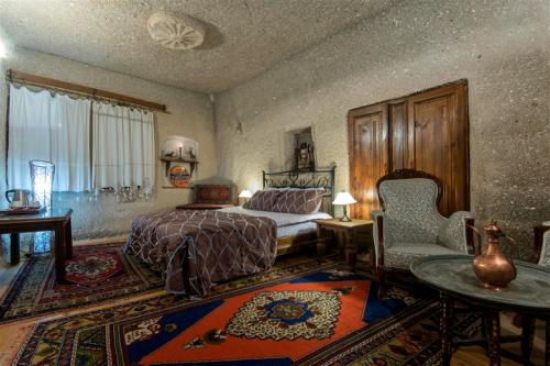 En eller flere senger på et rom på Antique Terrace Cave Suites