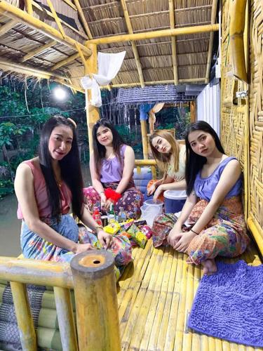 a group of women sitting on the floor of a building at Nakhon Si Ban Na Homestay in Nakhon Si Thammarat