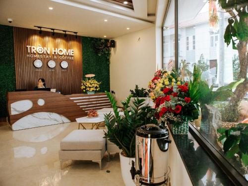 a flower shop with a bed and flowers in a store at Tròn Home in Quảng Ngãi