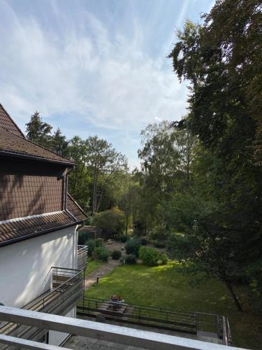 a group of people sitting on a porch looking at a garden at Hotel Seehaus in Horn-Bad Meinberg