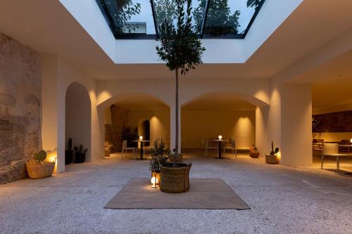 a large room with a ceiling with skylights at Hotel Avenida in Zaragoza