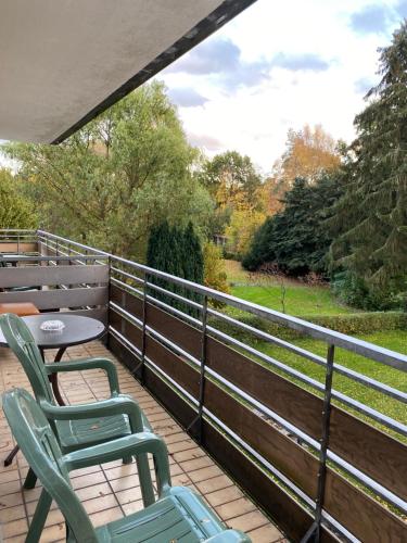 a patio with two chairs and a table on a balcony at Hotel Seehaus in Horn-Bad Meinberg