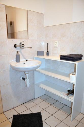 a bathroom with a sink and a mirror and a sink at Chata Zofka in Ižipovce