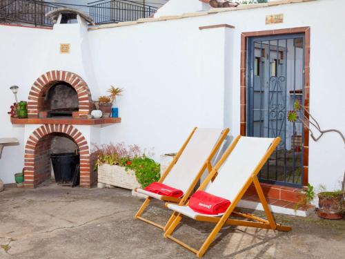 two deck chairs sitting outside of a house at Holiday Home Isis by Interhome in L'Escala