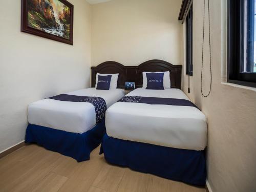 Ένα ή περισσότερα κρεβάτια σε δωμάτιο στο Woo Rooms Hotel