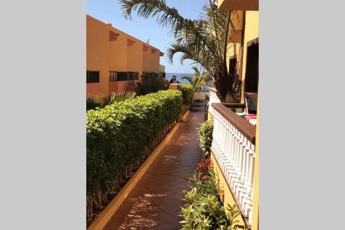 a sidewalk in front of a building with a fence at Holiday in Playa Calera - Swimming pool in Valle Gran Rey