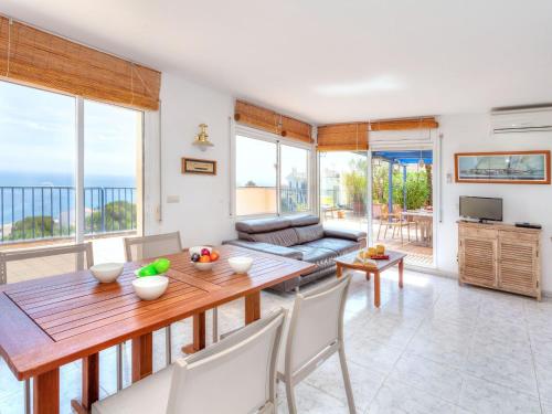 a living room with a table and chairs at Apartment L'Olivar II by Interhome in Llança