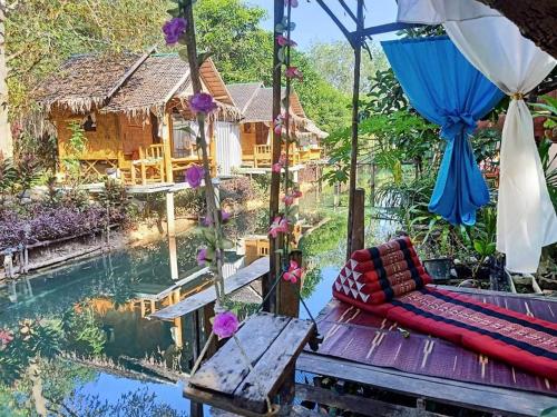 a room with a view of a pool and a house at Nakhon Si Ban Na Homestay in Nakhon Si Thammarat
