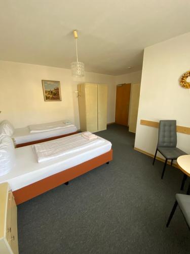 a hotel room with a bed and a chair at Hotel Seehaus in Horn-Bad Meinberg
