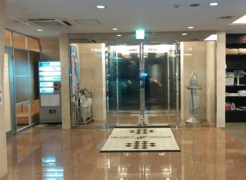 a lobby with a sign on the floor of a building at Kuretake-Inn Kakegawa in Kakegawa