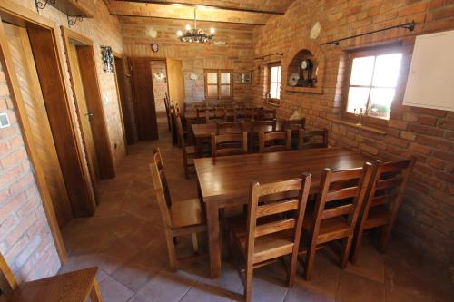 a dining room with wooden tables and chairs at Comenius Moravus vinařský dvůr in Mikulov