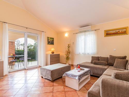 a living room with a couch and a table at Holiday Home Lara by Interhome in Vrsar