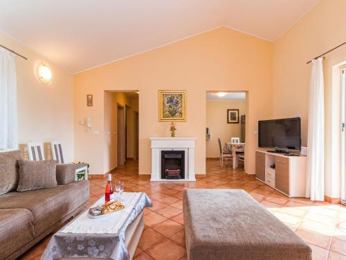 a living room with a couch and a fireplace at Holiday Home Lara by Interhome in Vrsar