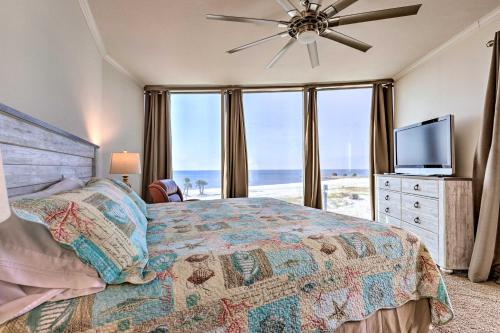 a bedroom with a bed with a view of the ocean at Sunny Beachfront Biloxi Condo with Resort Amenities! in Biloxi