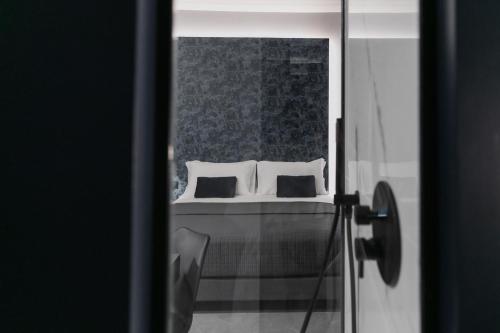 a bedroom with a bed with two pillows at WeLive in Carpi
