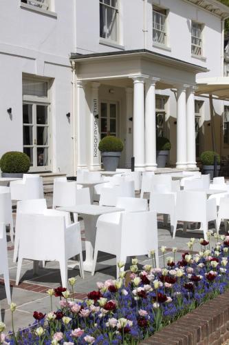 a row of white chairs and flowers in front of a building at Milsoms Kesgrave Hall in Ipswich