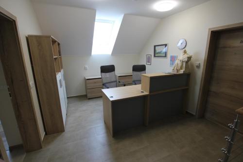 an office with two chairs and a desk and a window at Comenius Moravus vinařský dvůr in Mikulov