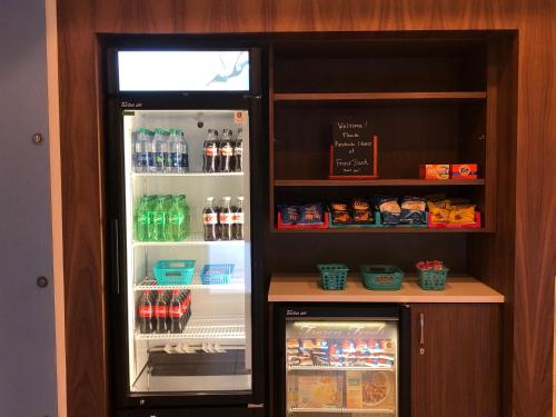 an open refrigerator with drinks and food in it at Holiday Inn Express Hotel & Suites Ashland by IHG in Ashland