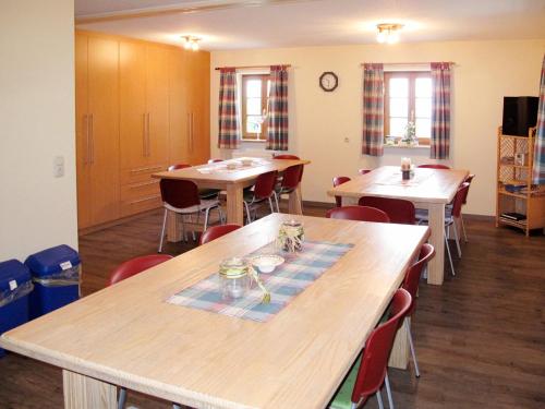a dining room with wooden tables and chairs at Holiday Home Kreuzbuche by Interhome in Viechtach