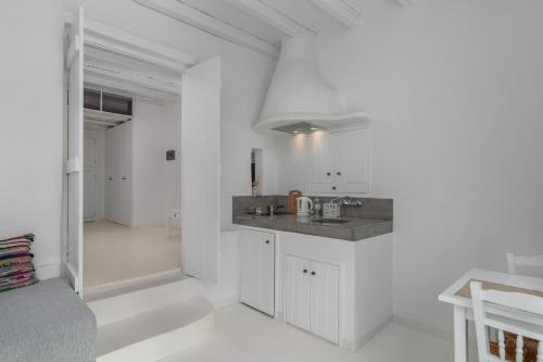 a white kitchen with a counter in a room at Thalassitra Private Pool Suites in Adamas