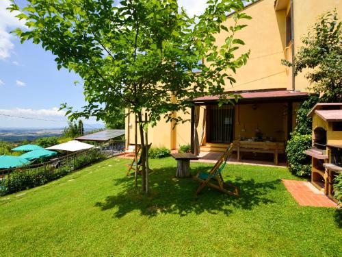 a garden with a tree and a house at Holiday Home Villetta nel Verde by Interhome in Montaione