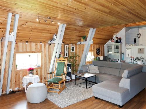 een woonkamer met een bank en een tafel bij Holiday Home Rødehuset - FJH670 by Interhome in Gjelland