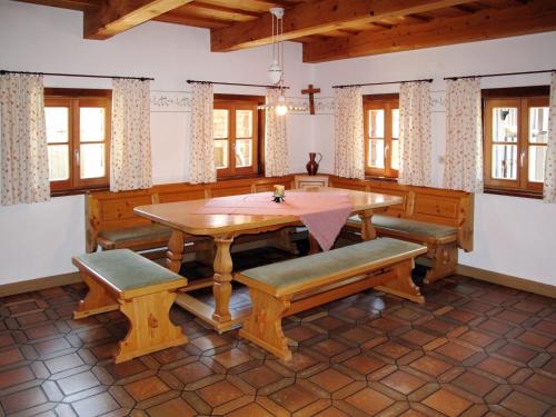 a dining room with a wooden table and benches at Holiday Home Mader by Interhome in Hochbruck