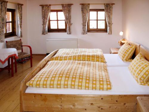 a bedroom with a large bed in a room with windows at Holiday Home Mader by Interhome in Hochbruck