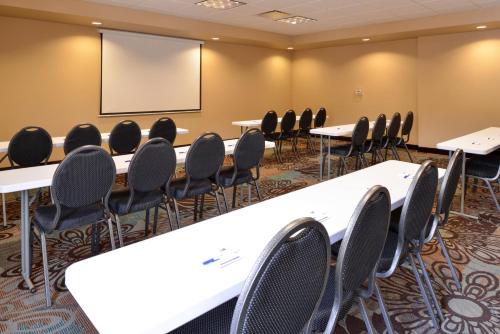 a conference room with tables and chairs and a whiteboard at Holiday Inn Express & Suites Globe by IHG in Globe