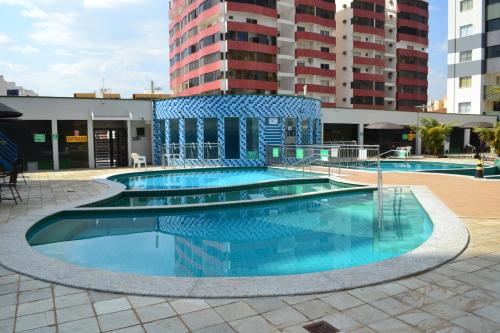a large swimming pool in the middle of a building at Aquarius Residence in Caldas Novas