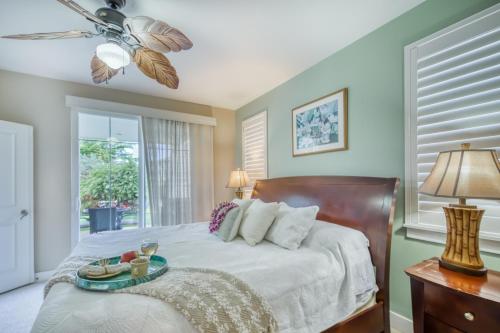 a bedroom with a bed with a tray of food on it at Plantations at Princeville #1312 in Princeville