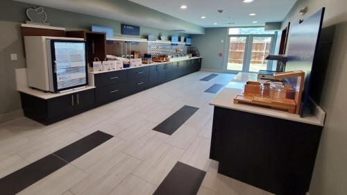 a large room with a counter in a store at Holiday Inn Express & Suites Arlington North – Stadium Area by IHG in Arlington