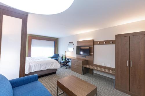 a hotel room with a bed and a desk at Holiday Inn Express & Suites Arlington North – Stadium Area by IHG in Arlington