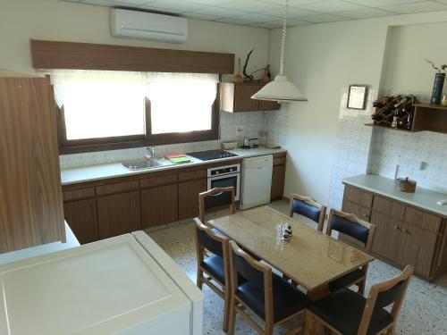 a kitchen with a table and chairs and a kitchen with a sink at Kakopetria Heights in Kakopetria