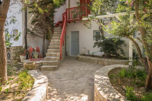 a house with a red staircase in front of it at Thalassitra Private Pool Suites in Adamas