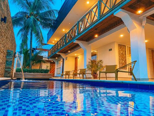 a swimming pool in a house with chairs around it at In Di House of Reggae Boutique in San Andrés